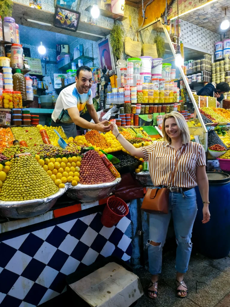 kobieta kupuje oliwki na souku w maroku